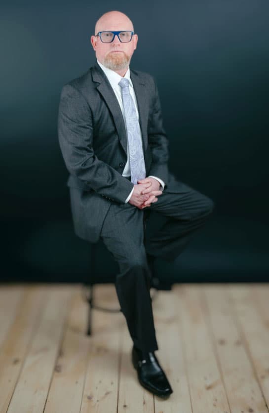 Attorney W. Scott Russell sitting on a stool